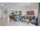 Open-concept living area with tile flooring, comfortable sofas, and access to the dining area at 3001 Red Ginger Rd, Kissimmee, FL 34747