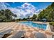 Resort-style swimming pool featuring lounge chairs and a sunny deck under a blue sky at 3001 Red Ginger Rd, Kissimmee, FL 34747