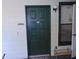 A green front door to unit 1007 with a shoe rack and a window at 3166 S Semoran Blvd # 1007, Orlando, FL 32822