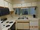 Well-lit kitchen featuring a double sink, modern appliances, and ample counter space at 3166 S Semoran Blvd # 1007, Orlando, FL 32822