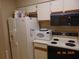 Cozy kitchen with white appliances and cabinets, great storage, and functional layout at 3166 S Semoran Blvd # 1007, Orlando, FL 32822