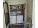Handy laundry room with white washer and dryer plus shelving for supplies at 3166 S Semoran Blvd # 1007, Orlando, FL 32822