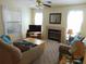 Comfortable living room featuring large windows, fireplace, and plush sofas at 3166 S Semoran Blvd # 1007, Orlando, FL 32822