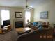 Cozy living room featuring a fireplace, ceiling fan, and comfortable seating at 3166 S Semoran Blvd # 1007, Orlando, FL 32822