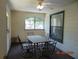 Enclosed porch featuring a ceiling fan, windows, and a dining set at 3166 S Semoran Blvd # 1007, Orlando, FL 32822