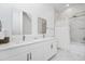 Bright bathroom with dual vanities, modern fixtures, and a tub-shower combo with white and gray marble-like tiles at 348 Famagusta Dr, Davenport, FL 33896