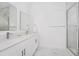 Bathroom featuring modern fixtures, dual sinks, marble floors, and tub with white tiled surround at 348 Famagusta Dr, Davenport, FL 33896