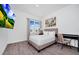Bedroom with queen bed, desk, large window with blind and curtain, and a wall mounted television at 348 Famagusta Dr, Davenport, FL 33896