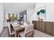 Dining area with a large table set for eight, modern decor, and an adjacent living area at 348 Famagusta Dr, Davenport, FL 33896