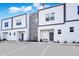 Modern townhome exterior with clean lines, gray accents, and ample parking space for residents and visitors at 348 Famagusta Dr, Davenport, FL 33896