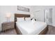 Comfortable main bedroom with a large bed, two nightstands, and a view of the en suite bathroom at 348 Famagusta Dr, Davenport, FL 33896