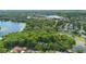 Picturesque aerial view captures a lake surrounded by lush greenery and stately homes at 4107 Gabriella Ln, Winter Park, FL 32792