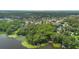 Overhead view of a lake community with lush greenery and docks along the shoreline at 4107 Gabriella Ln, Winter Park, FL 32792