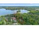 Breathtaking aerial view of a lakefront property with mature trees, offering serene privacy and natural beauty at 4107 Gabriella Ln, Winter Park, FL 32792
