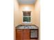 Wet bar with granite countertops, a stainless steel sink, and a beverage cooler at 4107 Gabriella Ln, Winter Park, FL 32792