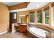 Well-lit bathroom offering a soaking tub with tile surround and a separate shower at 4107 Gabriella Ln, Winter Park, FL 32792