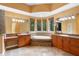 Bathroom featuring dual sinks, vanities and soaking tub with tile surround at 4107 Gabriella Ln, Winter Park, FL 32792