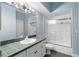 This bathroom features a tile countertop, a large mirror and a shower/tub combo at 4107 Gabriella Ln, Winter Park, FL 32792