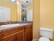 This bathroom features a wood vanity and a large mirror at 4107 Gabriella Ln, Winter Park, FL 32792