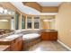 Bathroom with dual sinks, vanities and soaking tub with tile surround at 4107 Gabriella Ln, Winter Park, FL 32792