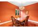 Formal dining room with wood floors features a chandelier and space for six at 4107 Gabriella Ln, Winter Park, FL 32792