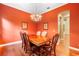 This formal dining room features a wood floor, decor, and space for six at 4107 Gabriella Ln, Winter Park, FL 32792