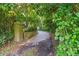 Private driveway lined with lush greenery leads to the property at 4107 Gabriella Ln, Winter Park, FL 32792