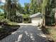 Charming home with a brick driveway and lush tropical landscaping surrounding the property at 4107 Gabriella Ln, Winter Park, FL 32792