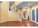 Entry foyer with wood floors, staircase, and view to a bathroom through an open doorway at 4107 Gabriella Ln, Winter Park, FL 32792
