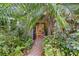 Lush front entrance with tropical landscaping leads to a welcoming doorway at 4107 Gabriella Ln, Winter Park, FL 32792