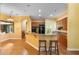 Kitchen with counter seating open to the living area, hardwood floors, and modern appliances at 4107 Gabriella Ln, Winter Park, FL 32792