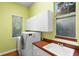 Bright laundry room with a washer, dryer, and sink at 4107 Gabriella Ln, Winter Park, FL 32792