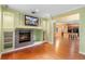 Well-lit living room with hardwood floors, a fireplace, custom built-ins and an open floor plan at 4107 Gabriella Ln, Winter Park, FL 32792