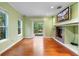 Bright living room with hardwood floors, fireplace, and large windows providing natural light and view of the outdoors at 4107 Gabriella Ln, Winter Park, FL 32792