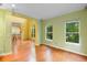 Spacious living area with hardwood floors, neutral tones, and large windows showcasing the outdoors at 4107 Gabriella Ln, Winter Park, FL 32792