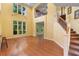 An open living space with high ceilings, large windows, and wood floors, and a staircase leading to the upper level at 4107 Gabriella Ln, Winter Park, FL 32792
