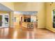 Open-concept living room and kitchen with hardwood floors and large windows offering plenty of natural light at 4107 Gabriella Ln, Winter Park, FL 32792