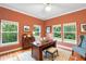 Bright home office with hardwood floors, three windows, and a comfortable workspace at 4107 Gabriella Ln, Winter Park, FL 32792