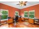 Large home office with built-in desks, hardwood floors, and multiple windows at 4107 Gabriella Ln, Winter Park, FL 32792
