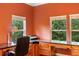 Home office with built-in desk, cabinets, hardwood floors, and lots of natural light at 4107 Gabriella Ln, Winter Park, FL 32792