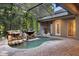 Beautiful screened-in pool with a rock waterfall and lush greenery, great for outdoor entertainment at 4107 Gabriella Ln, Winter Park, FL 32792