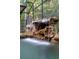 A stunning pool featuring a rock waterfall, enclosed within a screened patio for serene relaxation at 4107 Gabriella Ln, Winter Park, FL 32792