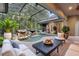 Beautiful screened-in pool area with a rock waterfall feature and outdoor seating area at 4107 Gabriella Ln, Winter Park, FL 32792
