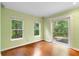 Bright room with hardwood floors, large windows, and sliding glass door leading to the backyard at 4107 Gabriella Ln, Winter Park, FL 32792