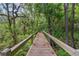 Wooden walkway amidst lush foliage at 4107 Gabriella Ln, Winter Park, FL 32792