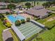 Aerial view of community amenities featuring a swimming pool, clubhouse, and shuffleboard courts at 425 Eagle Ridge Dr # 425, Davenport, FL 33837
