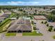 Aerial view showcasing community pool, tennis courts, clubhouse, and surrounding neighborhood at 425 Eagle Ridge Dr # 425, Davenport, FL 33837