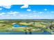 Scenic aerial shot of golf course with ponds, manicured green, and surrounding landscape on a sunny day at 425 Eagle Ridge Dr # 425, Davenport, FL 33837