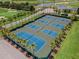 Aerial view of eight tennis courts with beautiful palm tree surroundings at 425 Eagle Ridge Dr # 425, Davenport, FL 33837