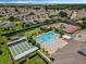 Aerial of community amenities with pool, tennis, and shuffleboard courts surrounded by homes at 425 Eagle Ridge Dr # 425, Davenport, FL 33837
